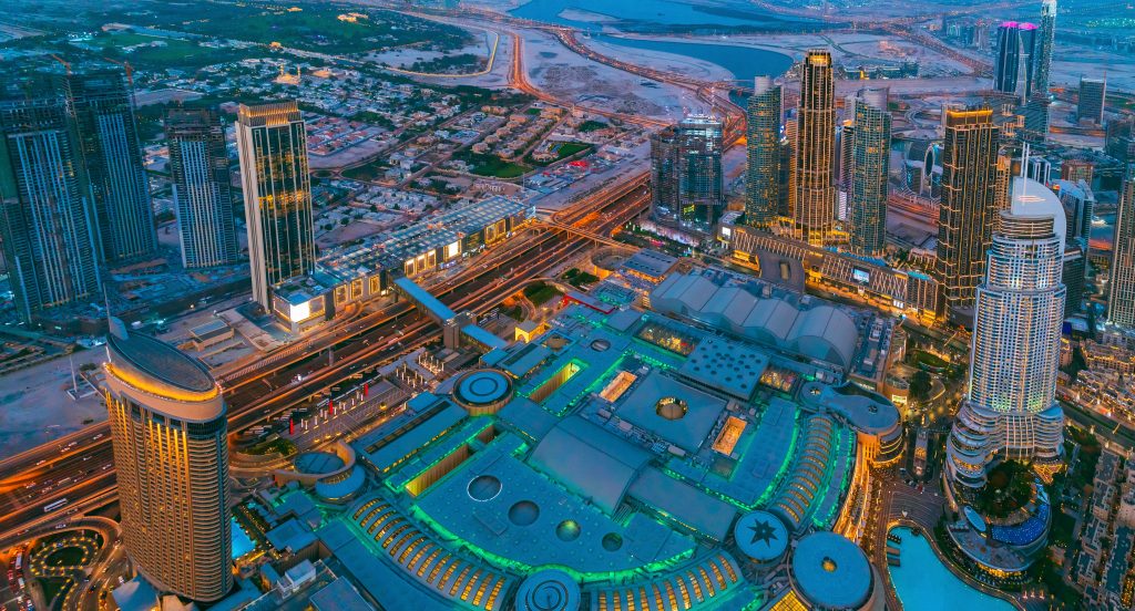 Aerial View Of Evening Night Scenic View Of Skyscraper. Night Traffic In Residential District in Dubai. Street Night Illumination. Night Scenic View Of Dubai Skyline. High quality photo.